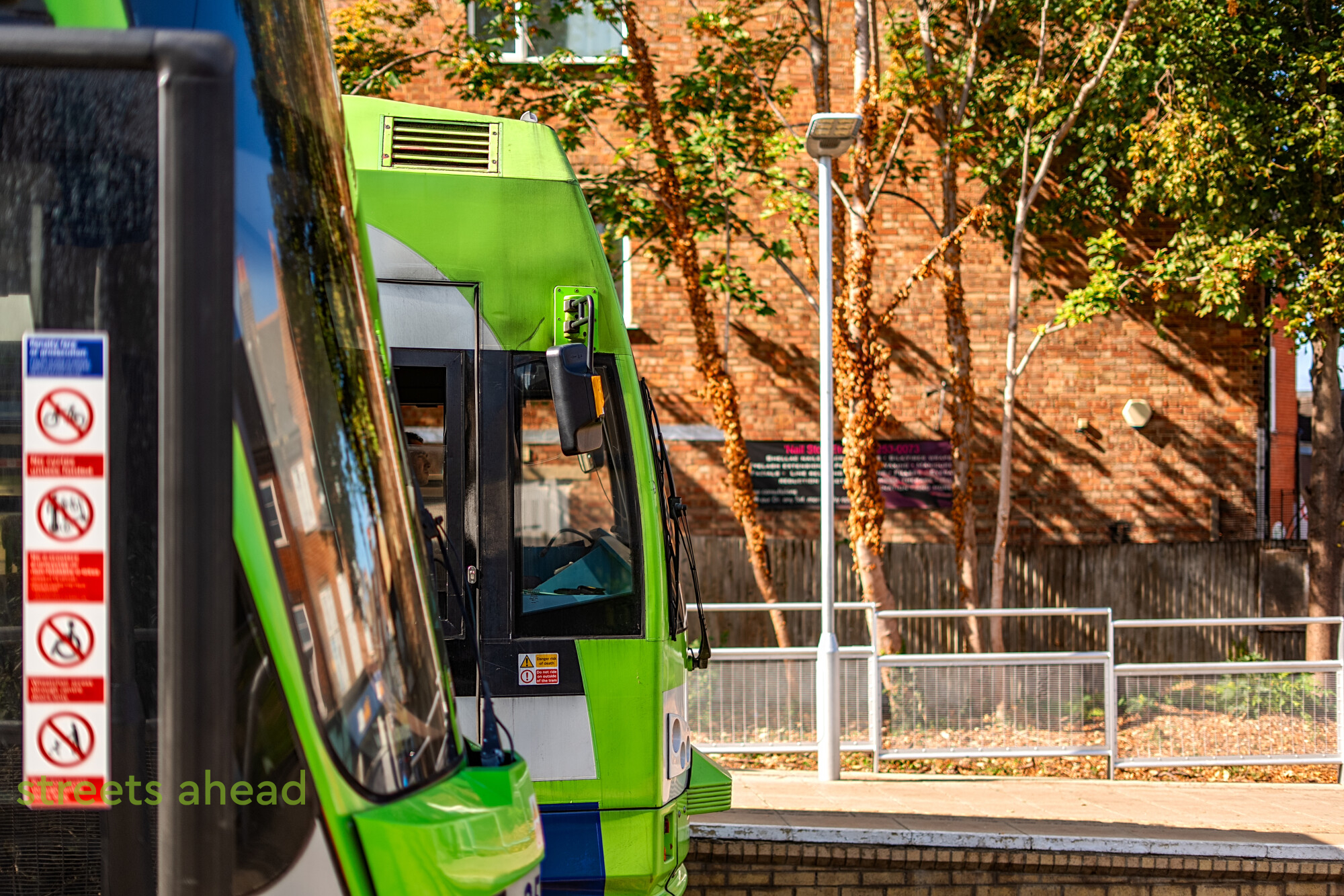 Trams passing at Addiscombe Two green London trams passing at Addiscombe stop