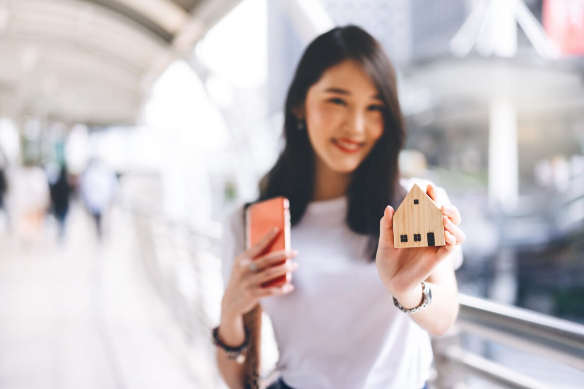 Focus,On,Home,Wooden,Model.,Blur,Asian,Happy,Business,Woman shutterstock 1897372189